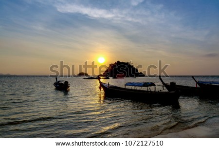 Early morning sunrise over the sea and a fishing boat
