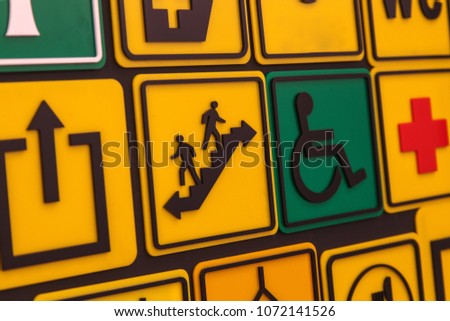 Different signs and navigation elements with arrows: wheelchairs, invalids, toilets, showers