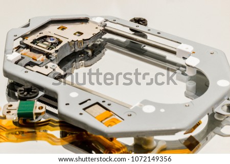Close up picture of computer disc drive components featuring different microchip parts against a white background