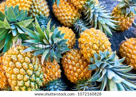 famous victoria pineapples on local market of Saint-Pierre, Reunion Island Royalty-Free Stock Photo #1072160828