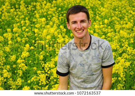 Cute Boy In Yellow Rape Seed Flower Field
