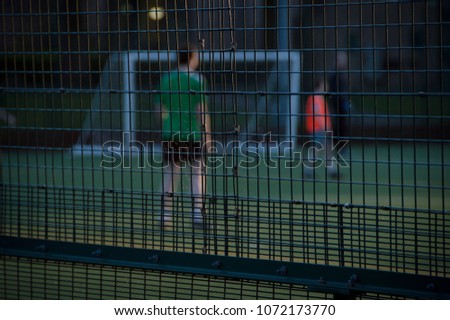Football Game Being Played Within Cage