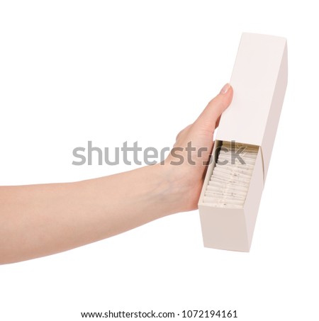 A pack of tea bags in hand on white background isolation