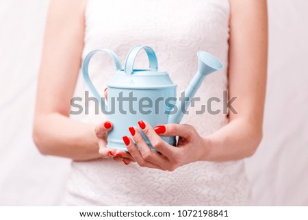Photo of woman holding watering can