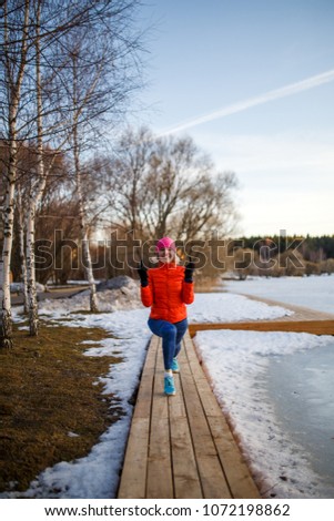 Photo of young athlete blonde at morning exercises in winter