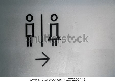 Toilet label on concrete wall