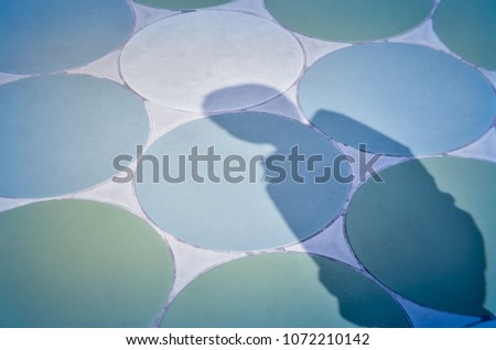 Shadow of a men on striped circle concrete background with place your text/ Abstract image