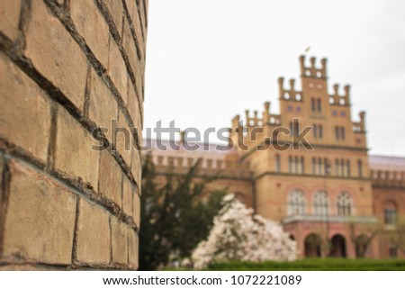 Brick wall on old university unfocused campus background