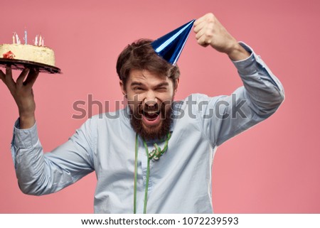   joyful man with a cake celebrates birthday, party                             