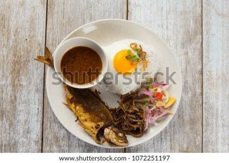 fried fish with rice with spices and curry
