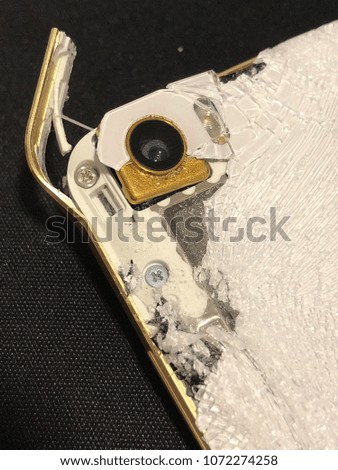 Modern mobile smartphone with broken screen isolated on black background.