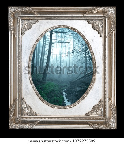 Picture in vintage frame. Mystical autumn forest with trail in blue fog. Beautiful landscape with trees, path, fog. Nature background. Foggy forest 