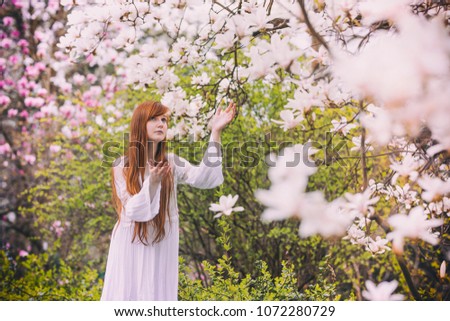 Red-haired girl with magnolias