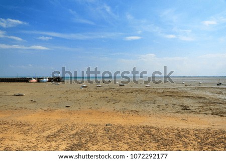 Beautiful view of the French beach at low tide with boats on dry land in Cancale, France, in summer