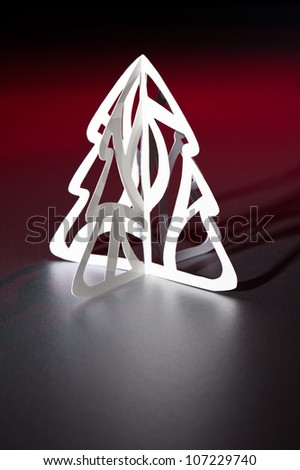 Paper cut Christmas tree in red and white with long shadow