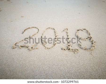 Happy new year 2019 on sand. Number 2019 on the beach.write yaer 2019 beside the sea.