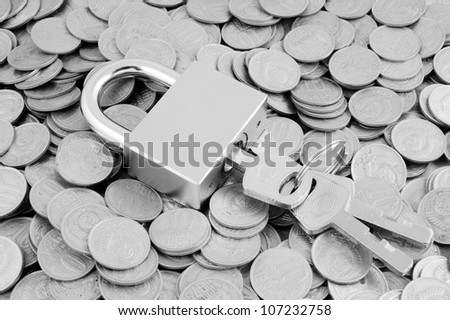 Padlock with keys on coins background