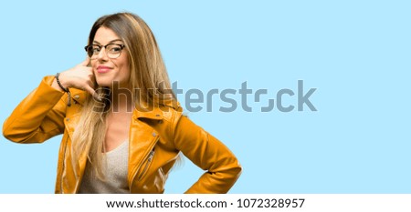 Beautiful young woman happy and excited making showing call me gesture with hand shaped like telephone