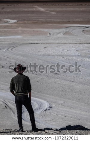 Man in the cowboy hat overlooking desert in bolivian Altiplano Royalty-Free Stock Photo #1072329011