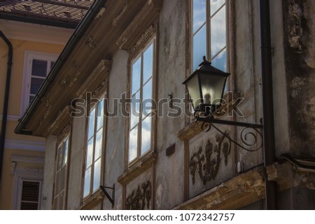Street lamp and windows of an old house in Slovenia, Europe