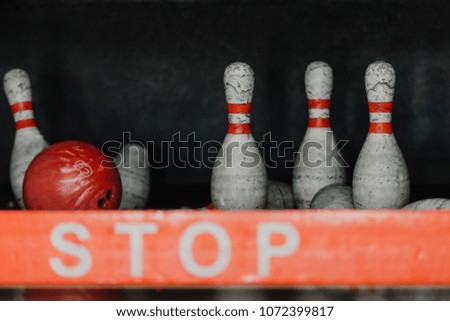 bowling ball crushing pins behind stop sign