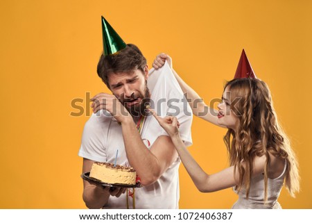 woman smeared finger in cake, emotional man                             