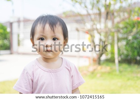 Baby Girl Standing In Park.