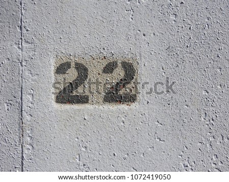 A figure of twenty-two on a white wall.