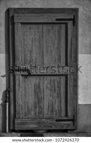 Ancient door in monochrome, cracked wooden entrance, sample for post card.