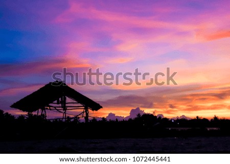 The atmosphere near the dark sea. Sky color purple, red, orange, yellow, blue after sunset. Silhouette on the Abandoned cottage. Beautiful nature wallpapers.
