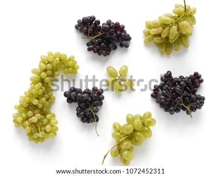 Black and green grapes isolated on a white background. The pattern of grapes of different varieties, top view. Food background.