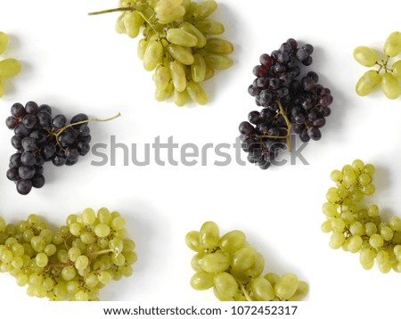 Black and green grapes isolated on a white background. The pattern of grapes of different varieties, top view. Food background.