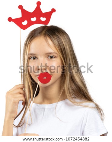 Funny girl playing with photo props accessories isolated on white