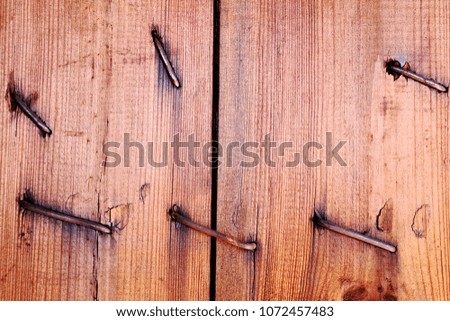 An old cracked board with nails. Wooden texture