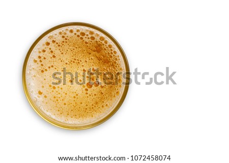 top view of beer bubbles in glass cup on white background. empty space for design. with clipping path. 