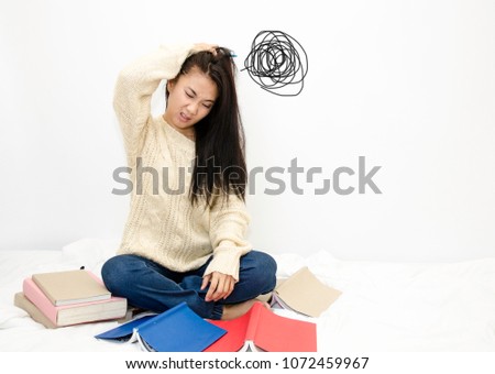 Asian women read books.Women wear white shirt do not understand the lesson.Read books do not understand.There is no doubt in reading.Bad reading
 Royalty-Free Stock Photo #1072459967