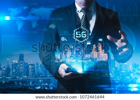 The abstract image of businessman using a smartphone overlay with 5g and cityscape hologram. the concept of 5G, communication, network, connection, internet of things.