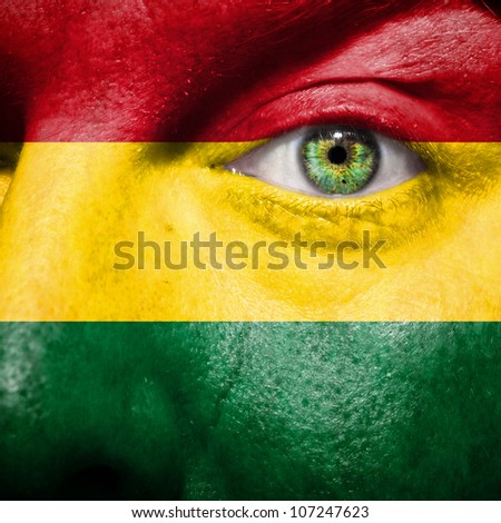 Flag painted on face with green eye to show Bolivia support