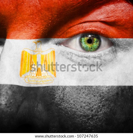 Flag painted on face with green eye to show Egypt support