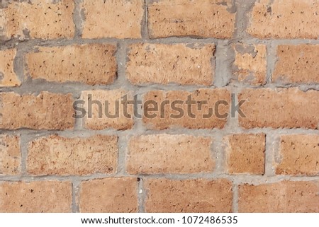 Old stone wall texture. Rough yellow stone wall background.
