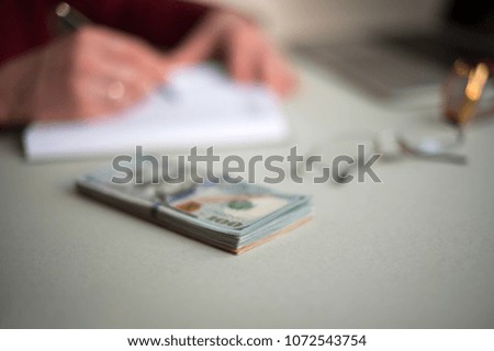 close-up desktop with dollars