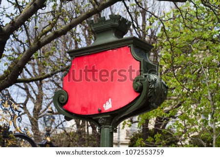side view closeup of outdoor royal coat of arms with classic medieval metallic design frame and empty vintage red panel