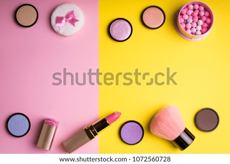 Makeup products and decorative cosmetics on color background flat lay. Fashion and beauty blogger concept. Top view. Copy space