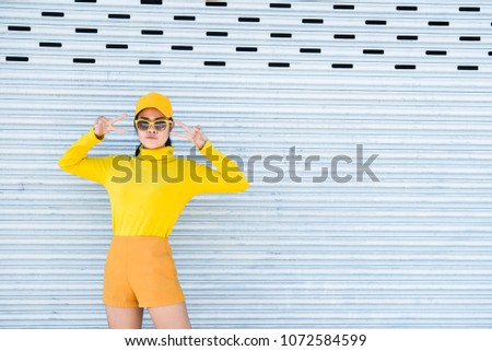 Portrait of beautiful asian woman in yellow cloths,Hipsters girl wear yellow hat  take a picture,Thailand people
