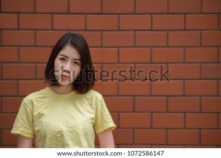 Portrait of beautiful asian chic girl pose for take a picture on brick wall,Lifestyle of teen thailand people,Modern woman happy concept