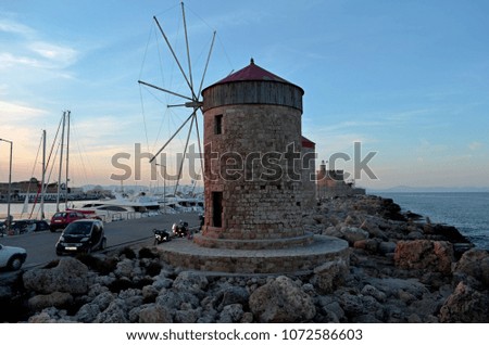 Rhodes island Greece.medieval mills and lighthouse on the island of Rhodes. Port near the city walls and transport. Around the sea and rocks