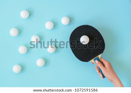 table tennis racket in hand on an abstract blue background, diagonal, texture

