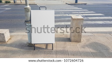 Urban City White Blank Advertisement Banner Mock Up In Metal Frame Standing on The Street .Isolated Template Clipping Path