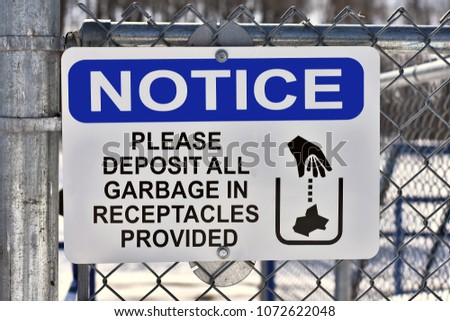 A close up image of a garbage disposal sign. 
