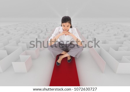 Woman sitting on a maze with an arrow